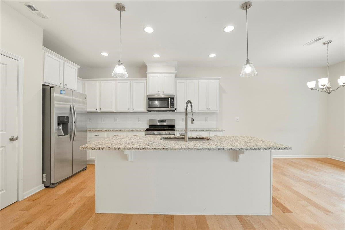 The kitchen island invites you to pull up a stool for conversation with the chef or just a quick meal. Kitchen