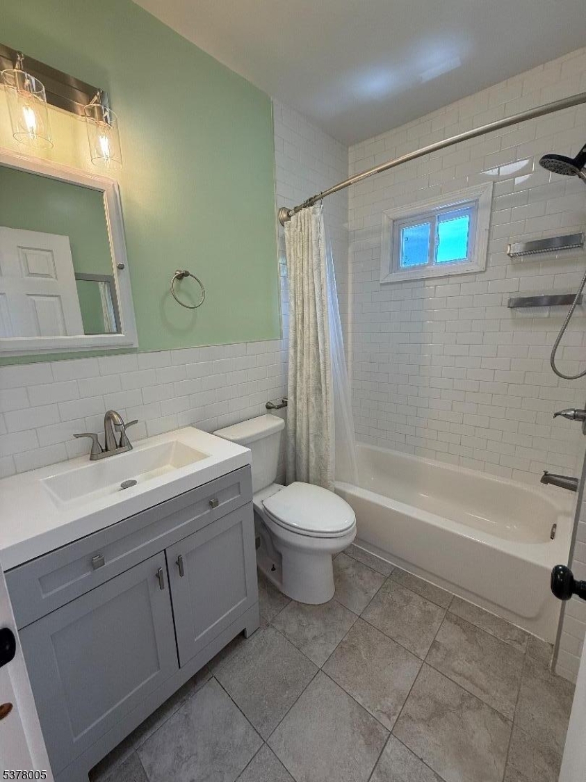 588 Chestnut Street, Unit 2 Orange, NJ 07050 - Photo 5 of 16 a bathroom with a sink toilet and shower