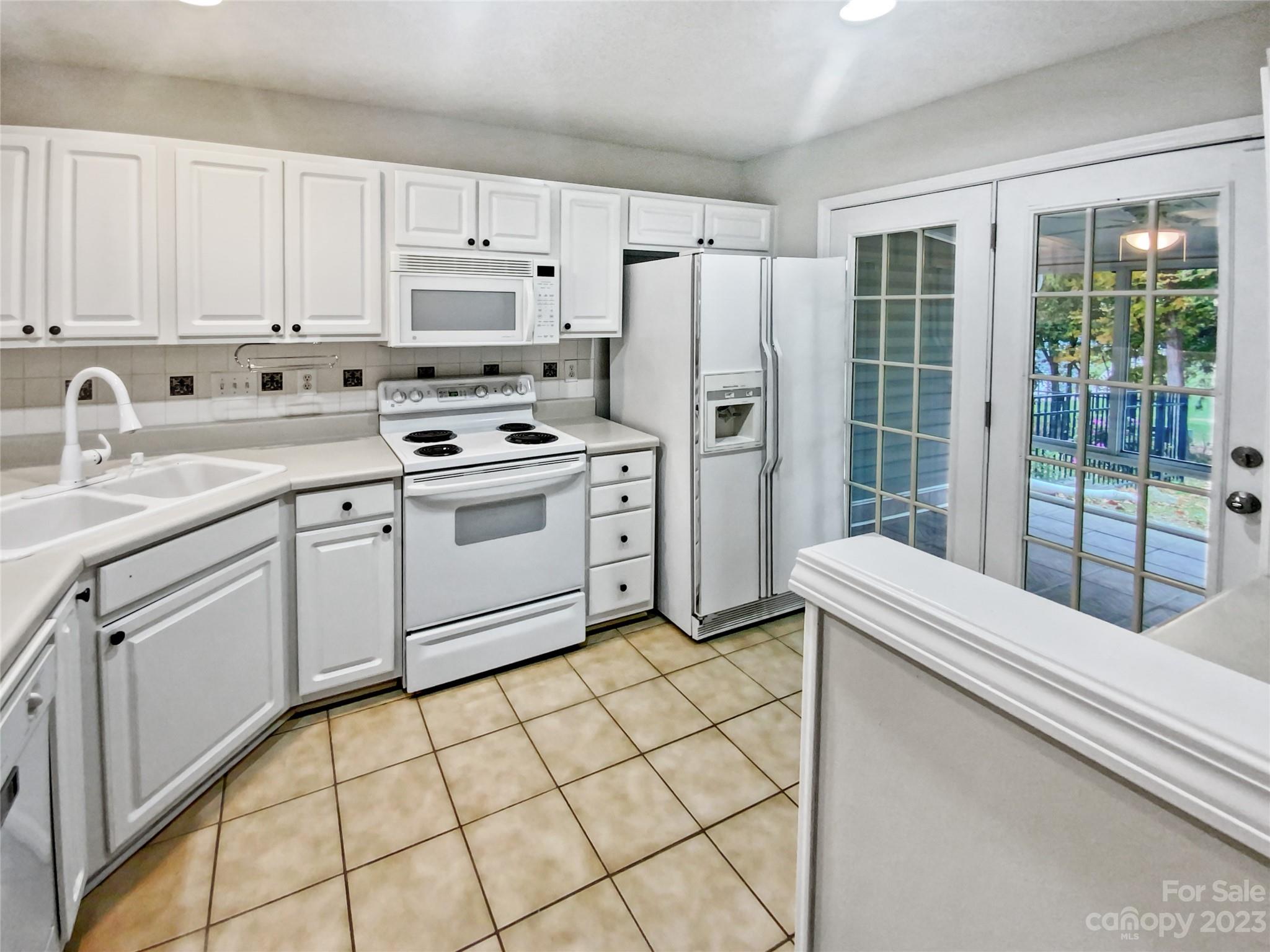 414 Robin Reed Court Pineville, NC 28134 - Photo 13 of 27 a kitchen with stainless steel appliances granite countertop a stove a sink and a refrigerator