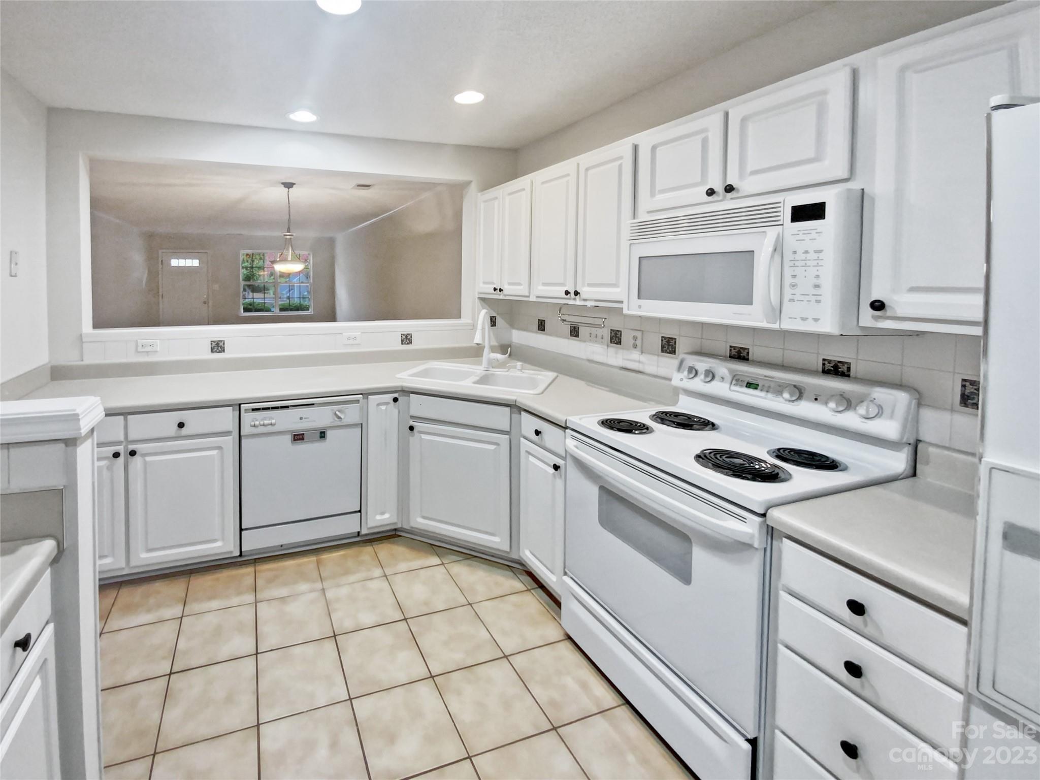 414 Robin Reed Court Pineville, NC 28134 - Photo 14 of 27 a kitchen with a stove sink and cabinets