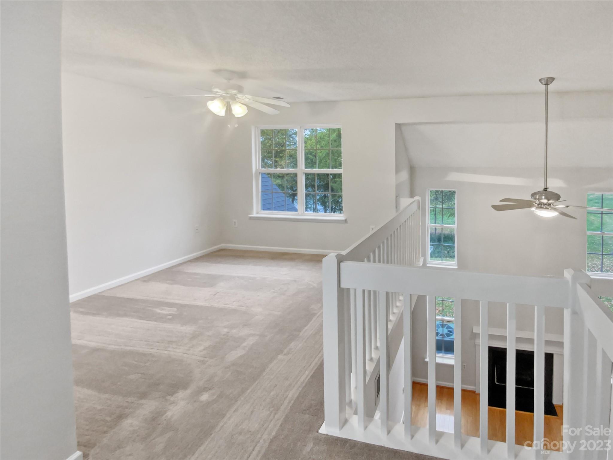 414 Robin Reed Court Pineville, NC 28134 - Photo 16 of 27 a view of a livingroom with a ceiling fan and window