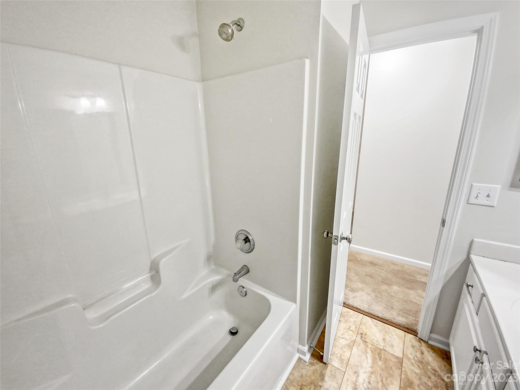 414 Robin Reed Court Pineville, NC 28134 - Photo 19 of 27 a bathroom with a bathtub and a shower