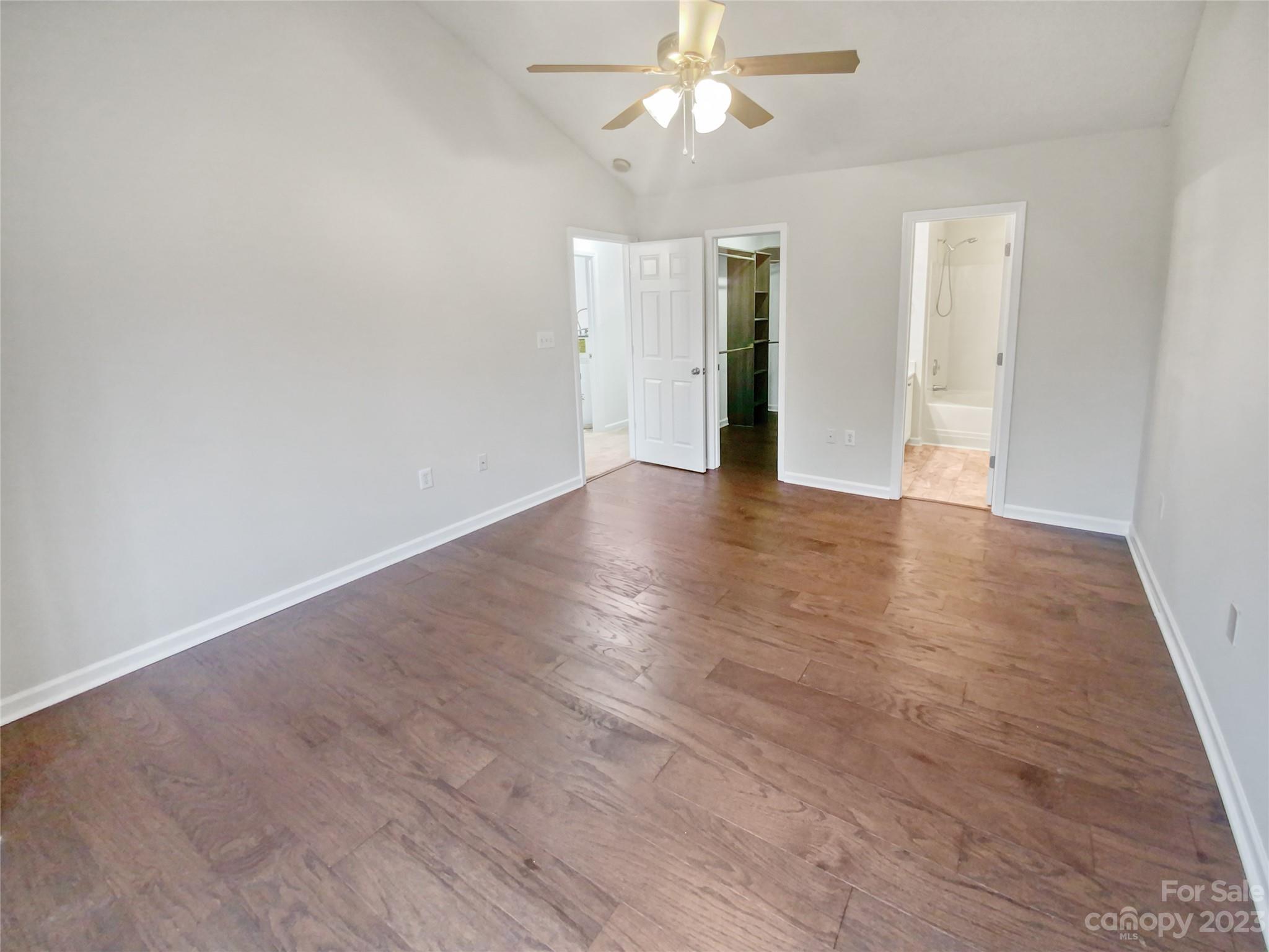 414 Robin Reed Court Pineville, NC 28134 - Photo 22 of 27 an empty room with wooden floor and a ceiling fan