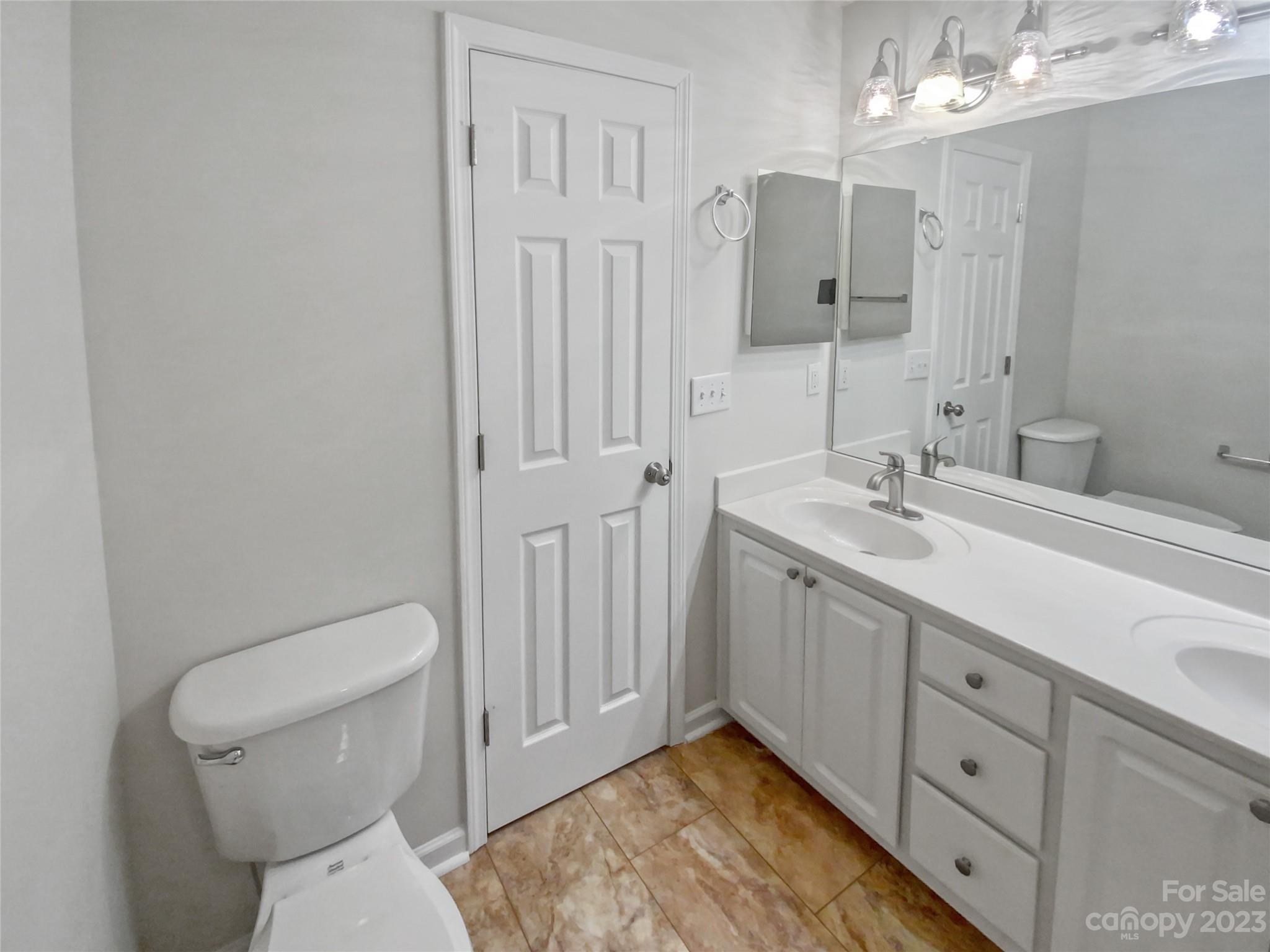 414 Robin Reed Court Pineville, NC 28134 - Photo 24 of 27 a spacious bathroom with a toilet a sink and mirror