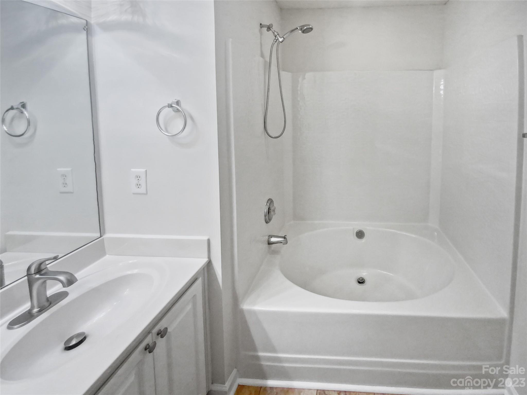 414 Robin Reed Court Pineville, NC 28134 - Photo 25 of 27 a bathroom with a tub sink vanity and shower