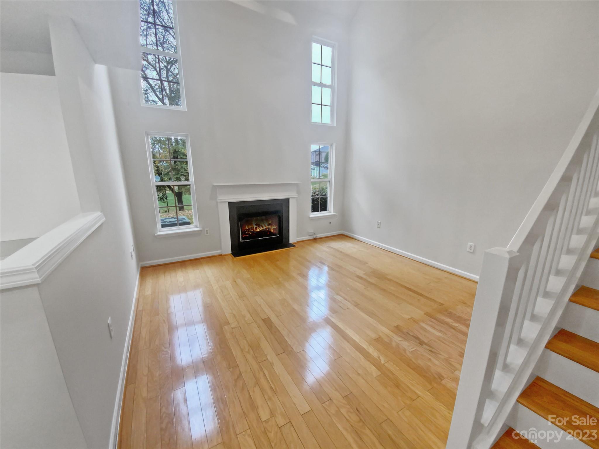 414 Robin Reed Court Pineville, NC 28134 - Photo 3 of 27 a view of empty room with wooden floor and fireplace