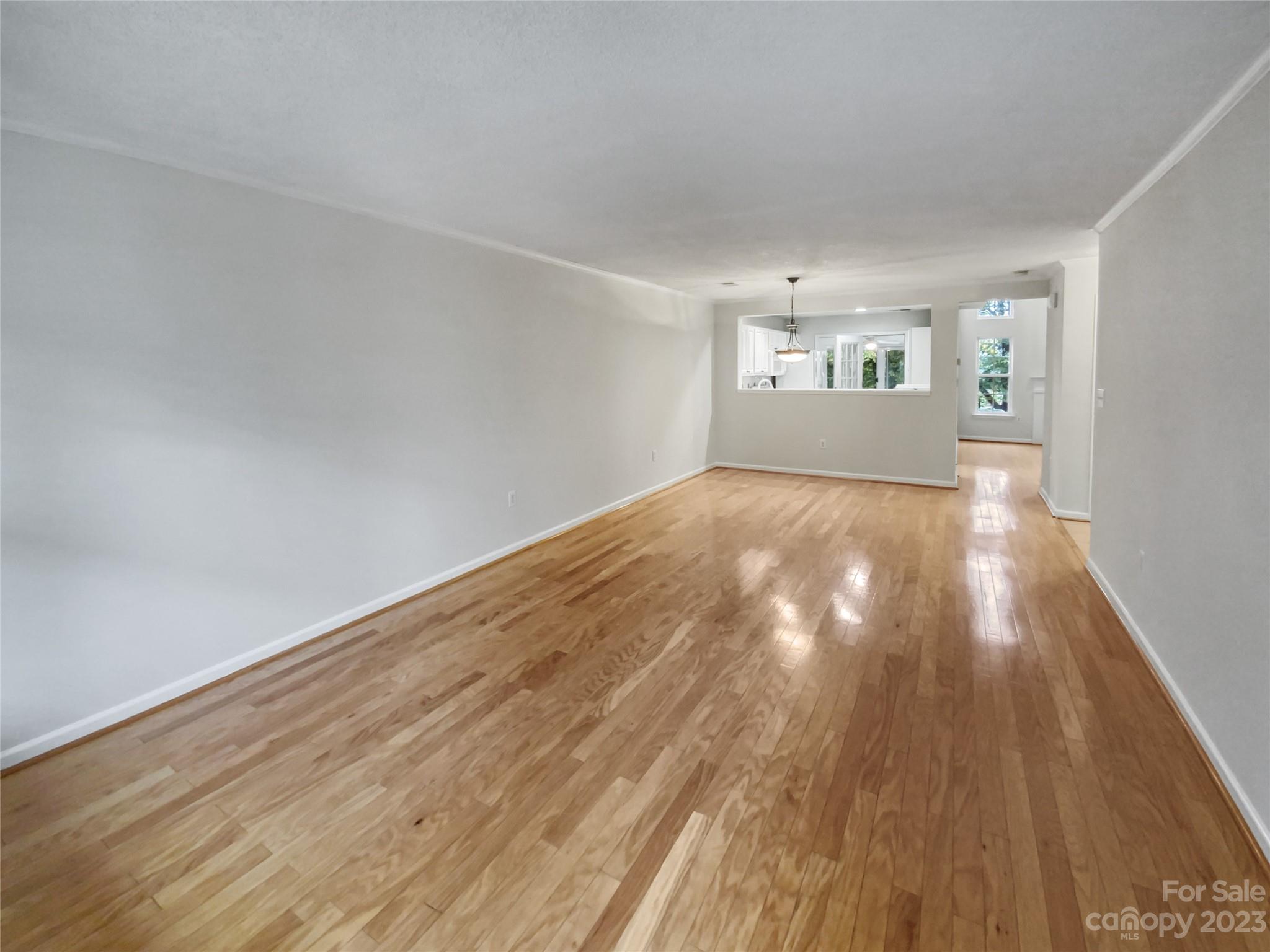 414 Robin Reed Court Pineville, NC 28134 - Photo 7 of 27 a view of empty room with wooden floor