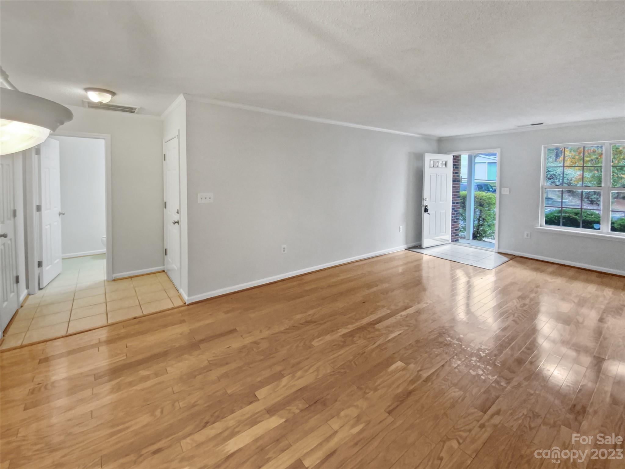 414 Robin Reed Court Pineville, NC 28134 - Photo 9 of 27 a view of an empty room with wooden floor and a window