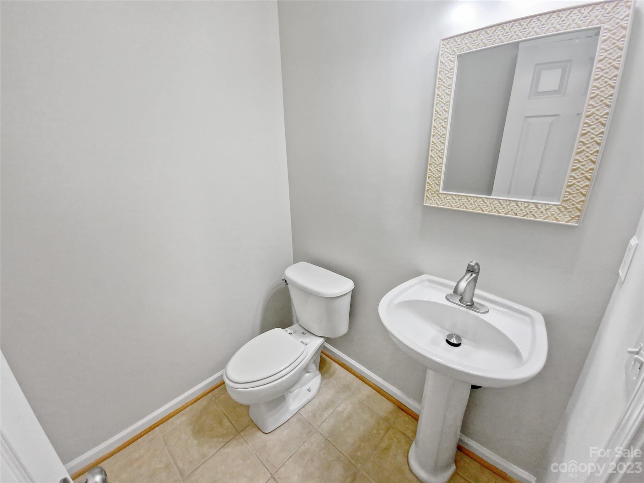 414 Robin Reed Court Pineville, NC 28134 - Photo 10 of 27 a bathroom with a toilet sink and mirror