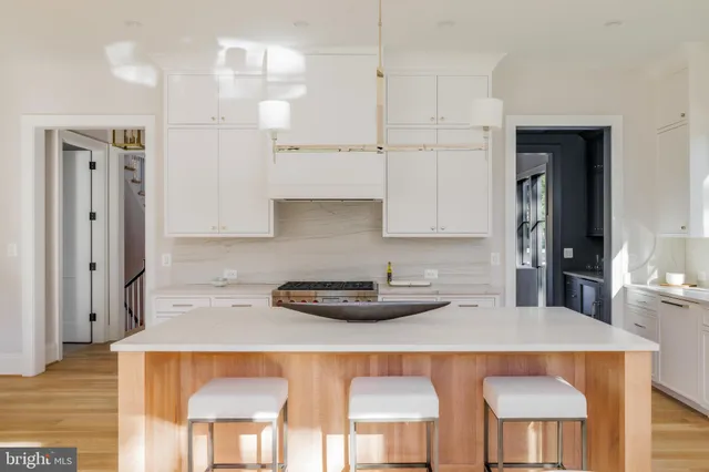 a kitchen with stainless steel appliances a sink and cabinets