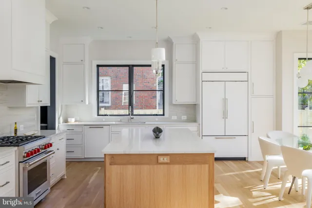 a kitchen with stainless steel appliances granite countertop a sink and a stove
