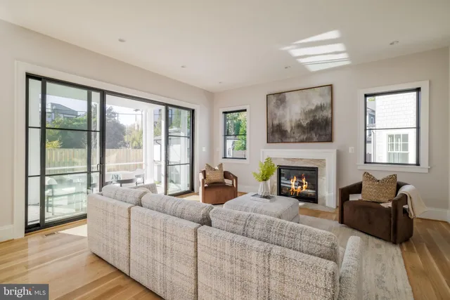 a living room with furniture large window and a fireplace