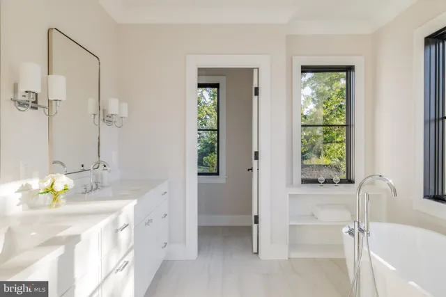 a spacious bathroom with a bathtub sink and mirror