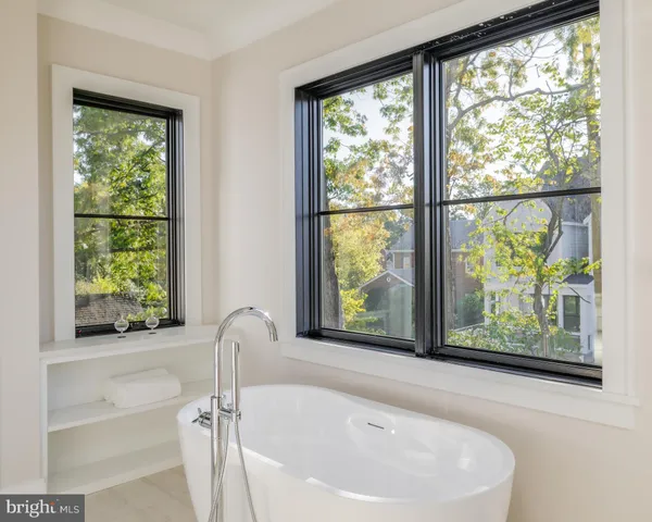 a bathroom with a bathtub and window