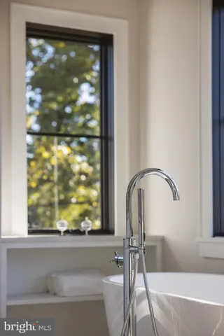 a bathroom with a bathtub and window