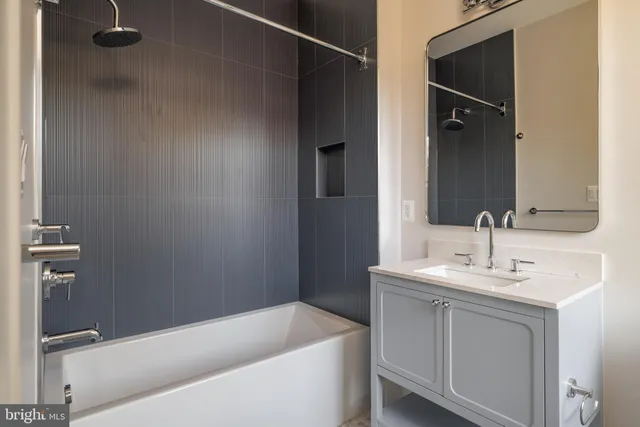 a bathroom with a sink a bathtub and a mirror