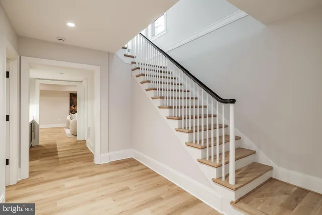 a view of entryway and hall with wooden floor