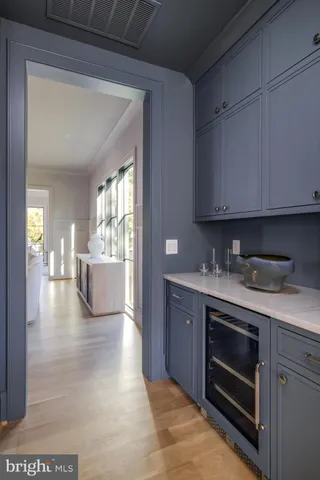 a kitchen with a stove and white cabinets