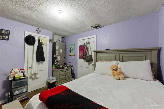 a bedroom with a bed and a flat tv screen