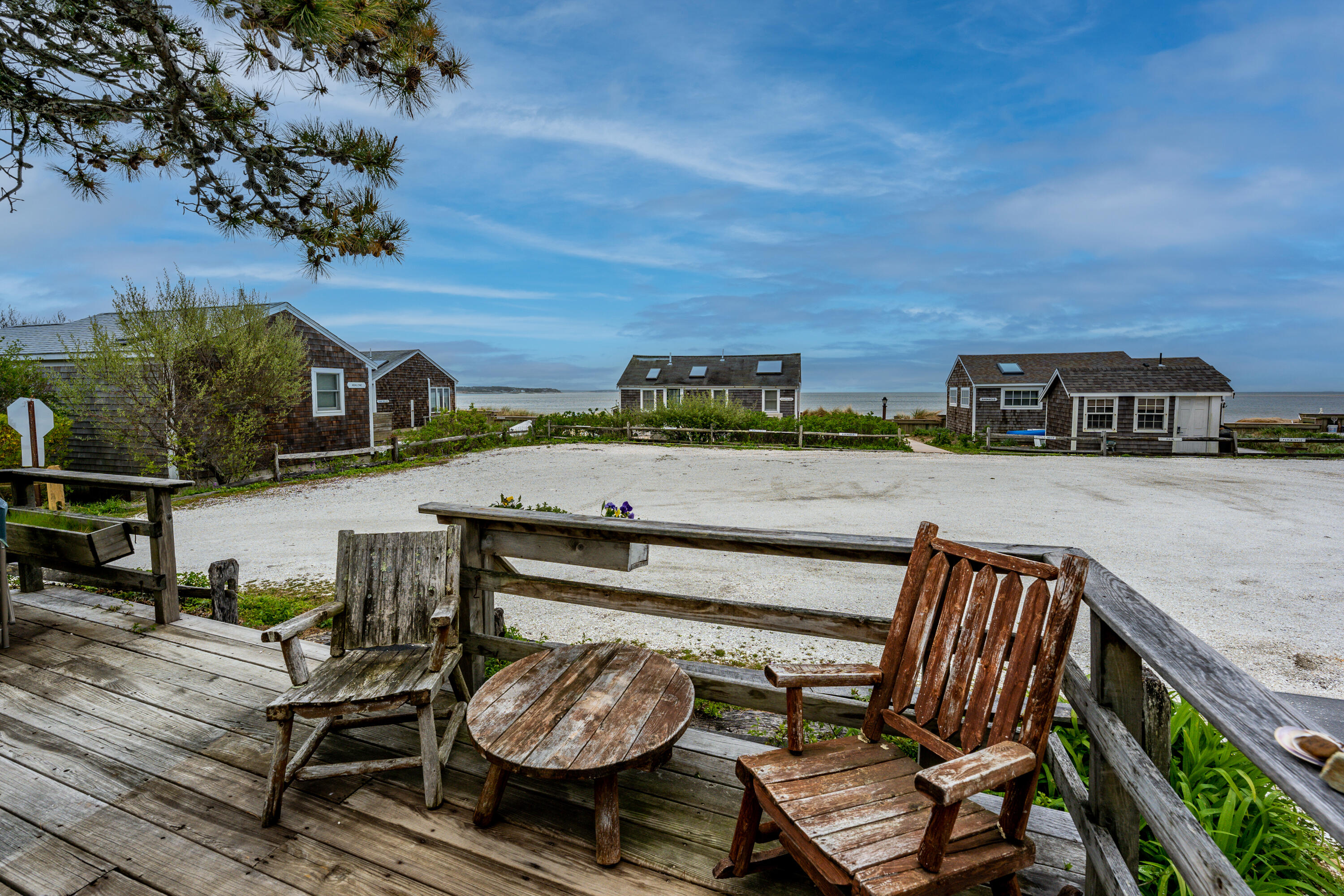 575 Chequessett Neck Road, Unit KSCALLLOP Wellfleet, MA 02667 - Photo 4 of 17 a view of a balcony with two chairs and a potted plant