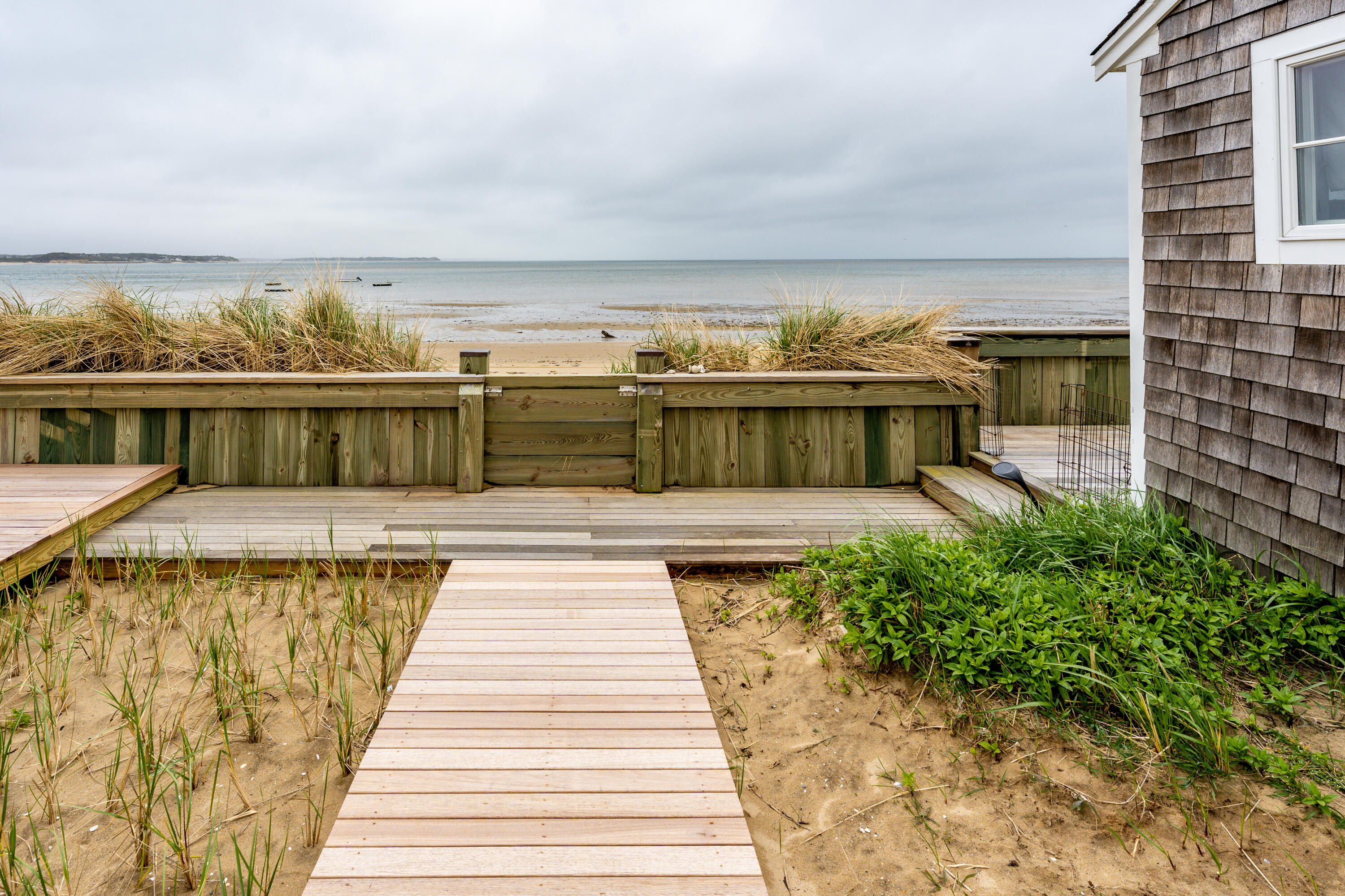 575 Chequessett Neck Road, Unit KSCALLLOP Wellfleet, MA 02667 - Photo 5 of 17 a view of a balcony with two chairs and a dining table