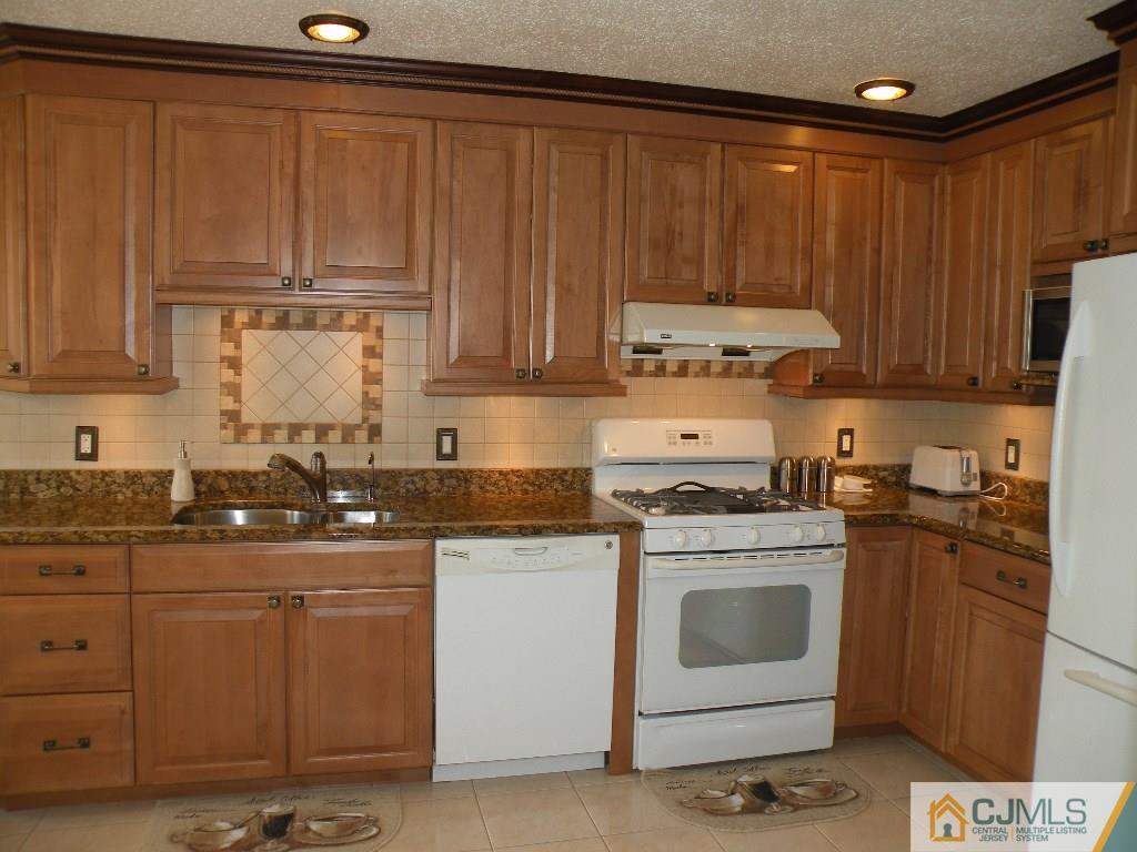 108 Orion Road Piscataway, NJ 08854 - Photo 2 of 16 a kitchen with granite countertop cabinets stainless steel appliances and a sink