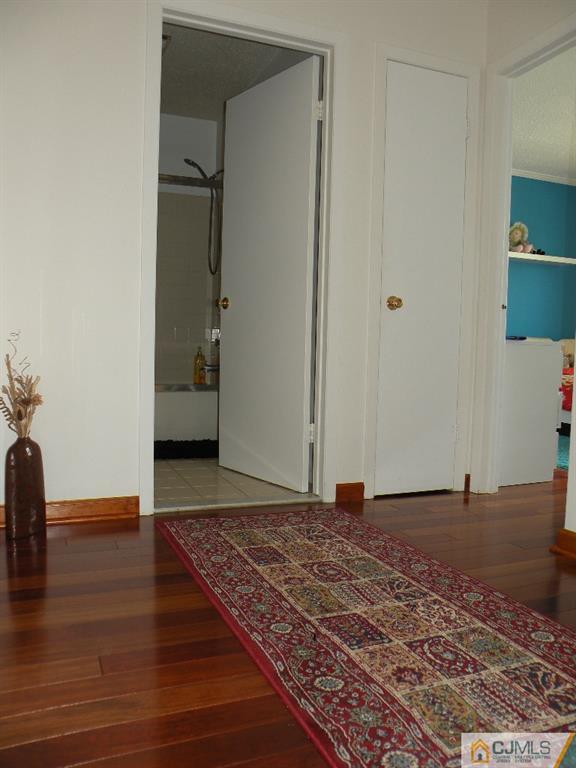 108 Orion Road Piscataway, NJ 08854 - Photo 11 of 16 a view of a room with wooden floor and a lamp on table