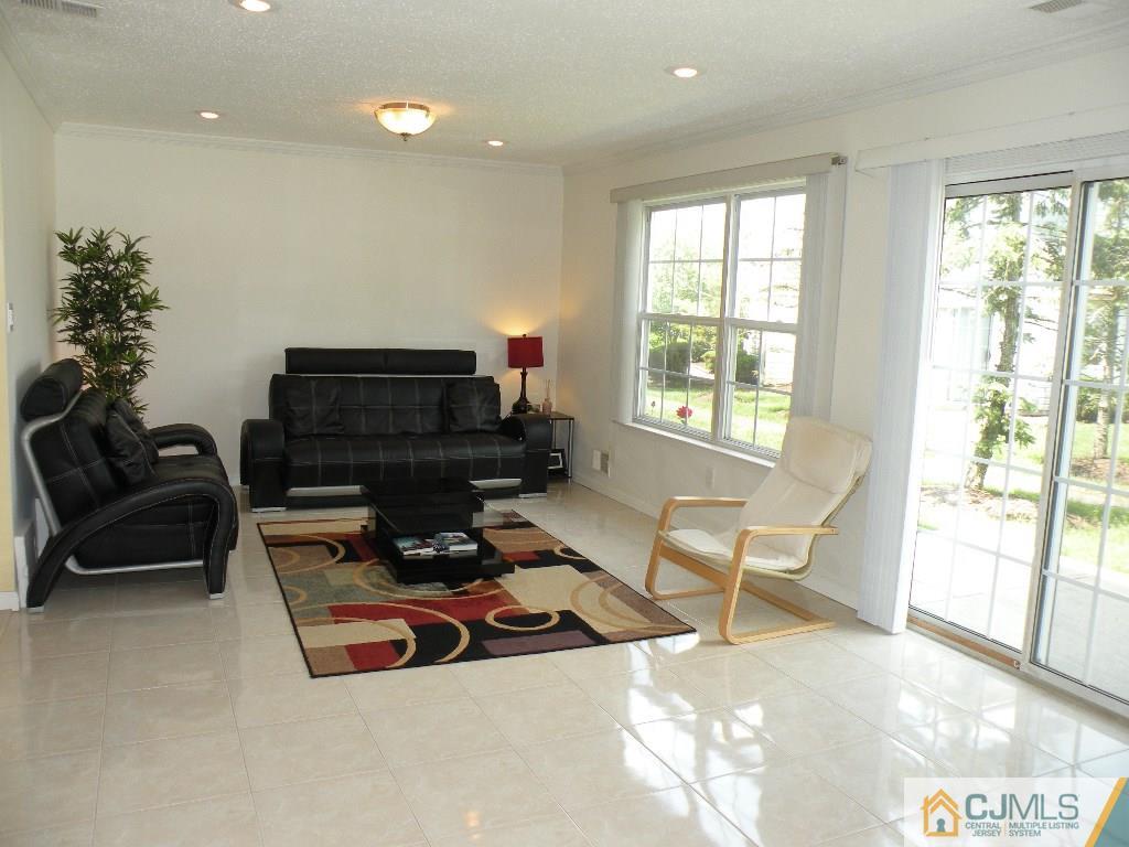 108 Orion Road Piscataway, NJ 08854 - Photo 7 of 16 a living room with furniture a flat screen tv and a large window