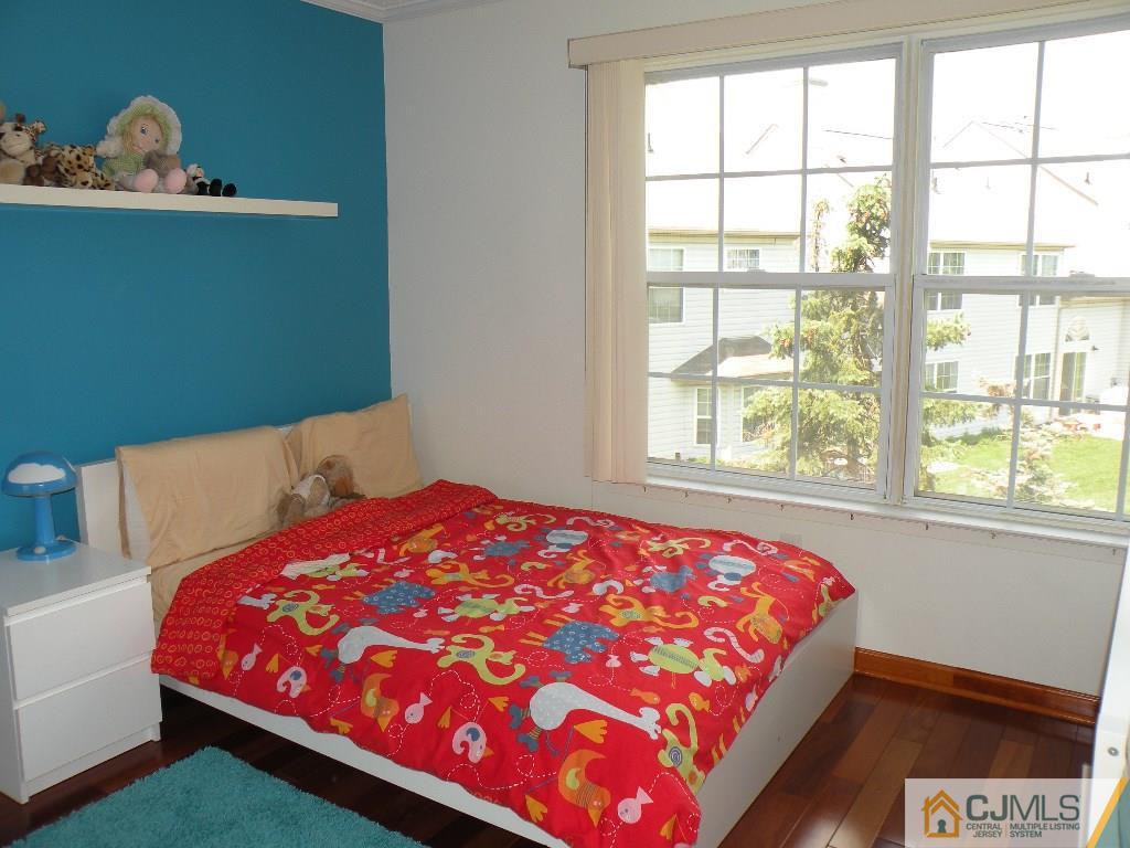 108 Orion Road Piscataway, NJ 08854 - Photo 10 of 16 a bed sitting in a bedroom next to a window