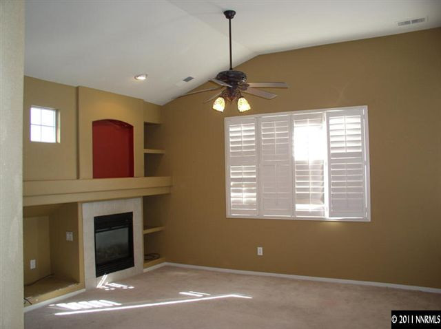 9752 Ripple Way Reno, NV 89521 - Photo 7 of 13 a view of livingroom with window fireplace and window