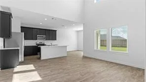 a view of a kitchen with microwave and cabinets