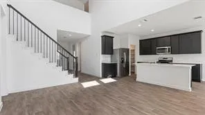 a view of kitchen with microwave refrigerator stove microwave and cabinets