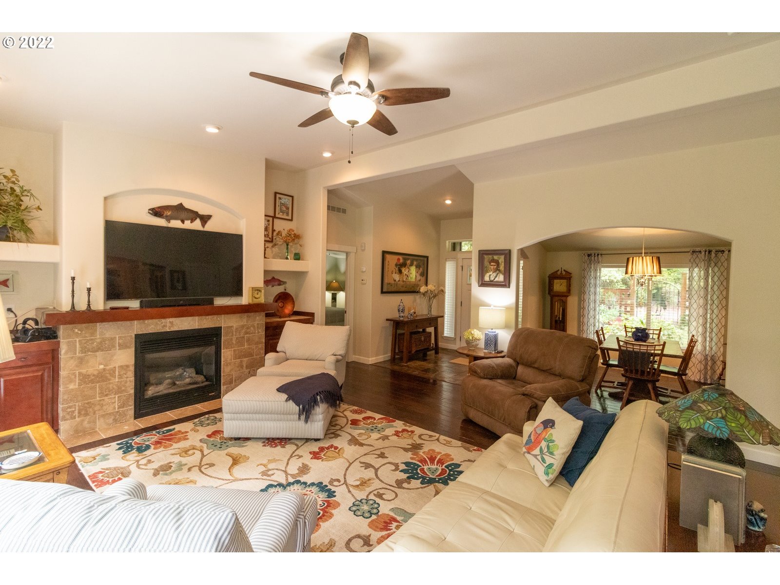 5732 Nicholson Road Florence, OR 97439 - Photo 11 of 31 a living room with furniture a flat screen tv and a fireplace