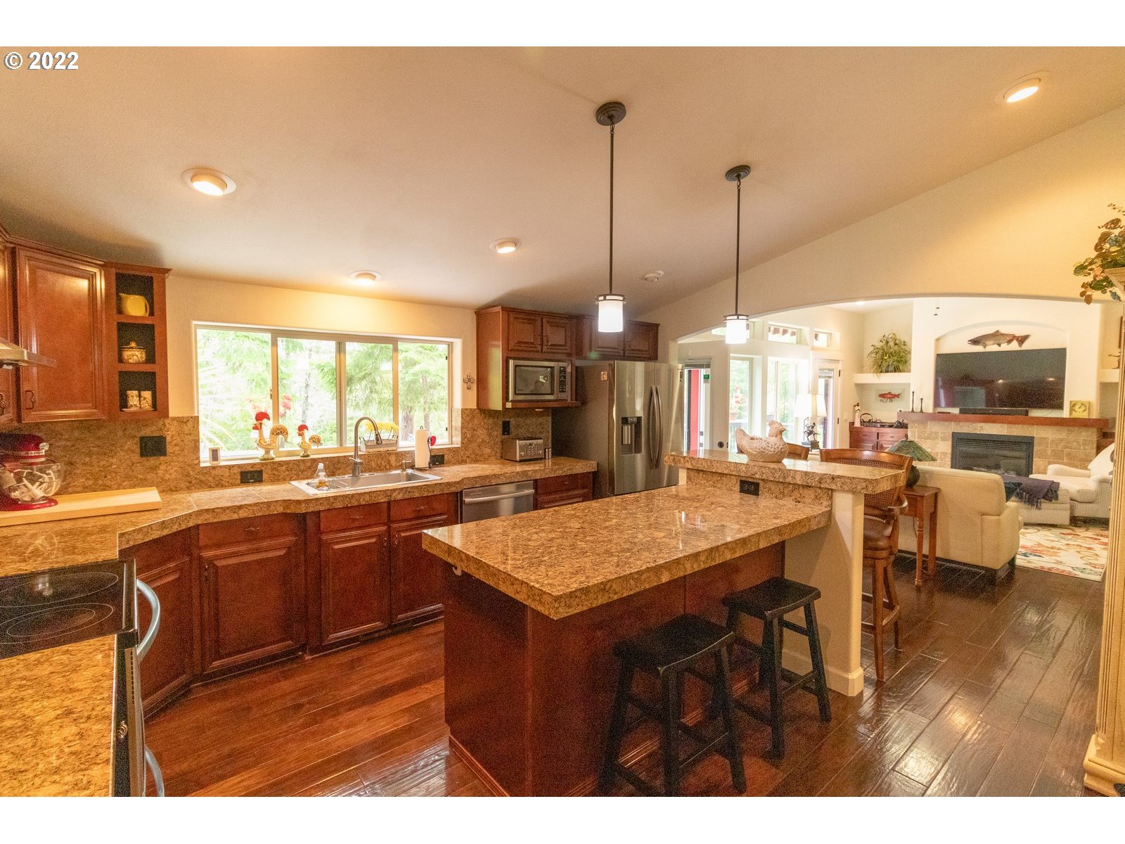 5732 Nicholson Road Florence, OR 97439 - Photo 14 of 31 a kitchen with stainless steel appliances granite countertop counter space a sink and living room view