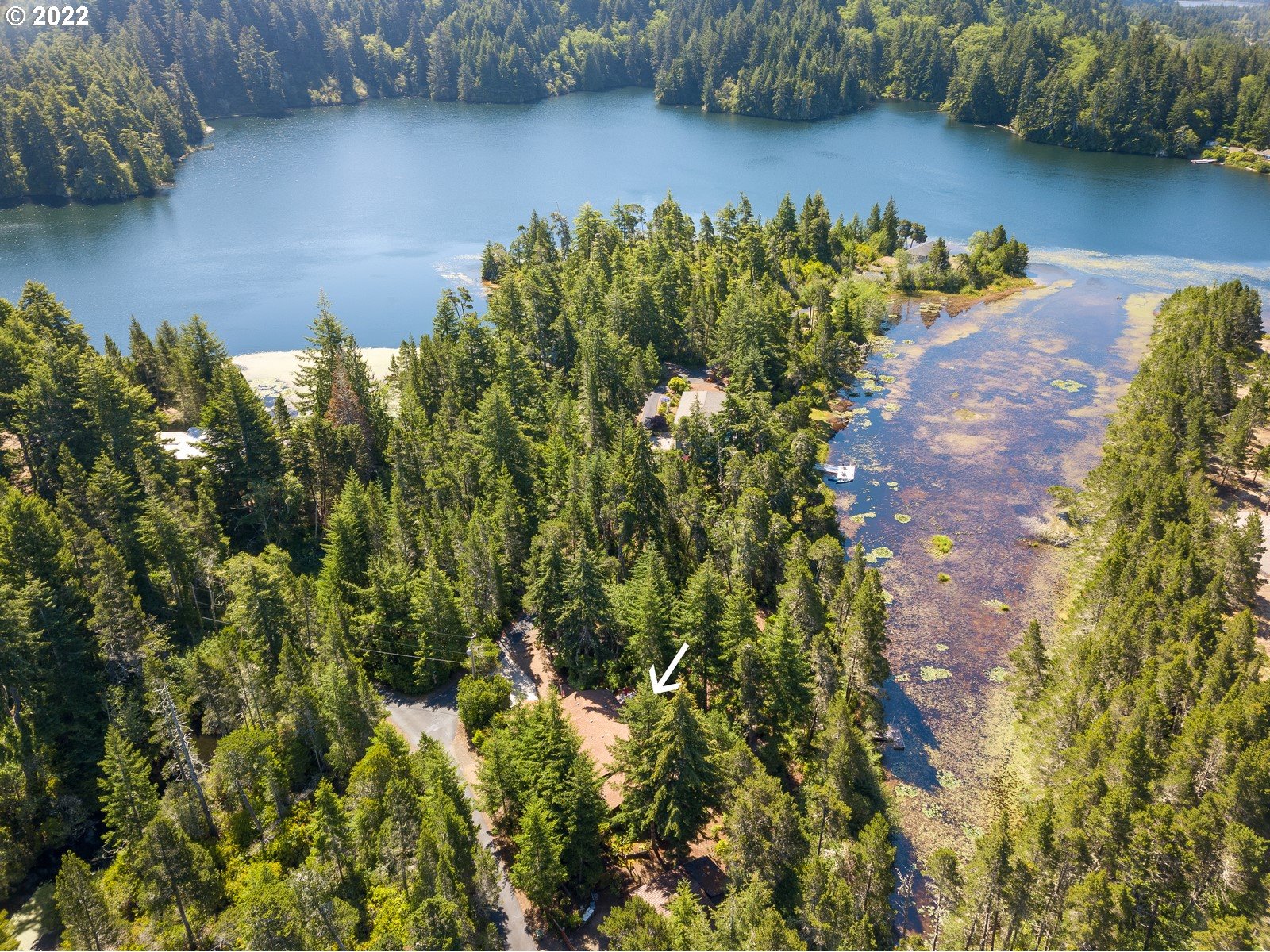 5732 Nicholson Road Florence, OR 97439 - Photo 29 of 31 a view of a lake with a building in the background