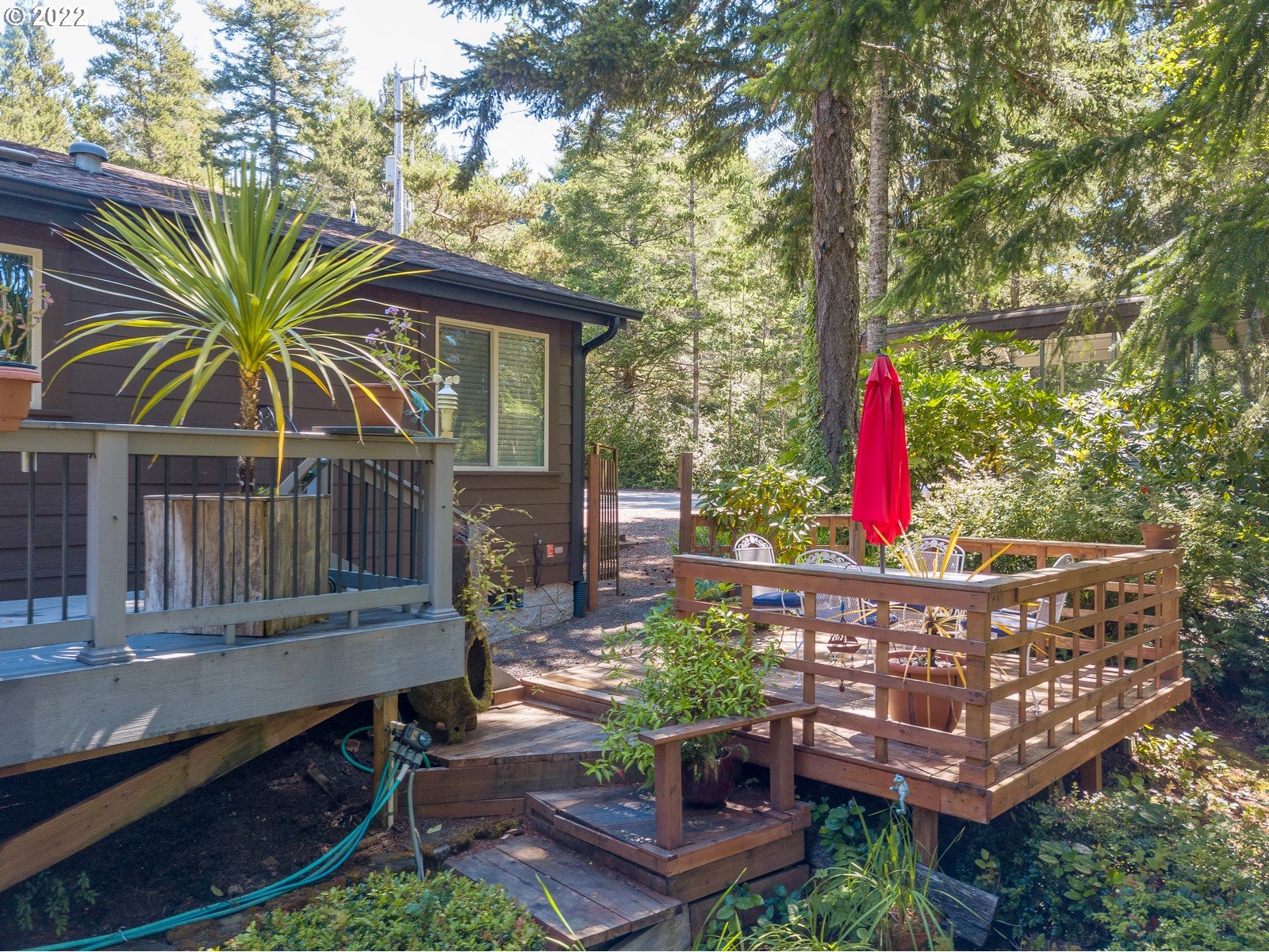 5732 Nicholson Road Florence, OR 97439 - Photo 4 of 31 a view of a roof deck with wooden fence and a bench