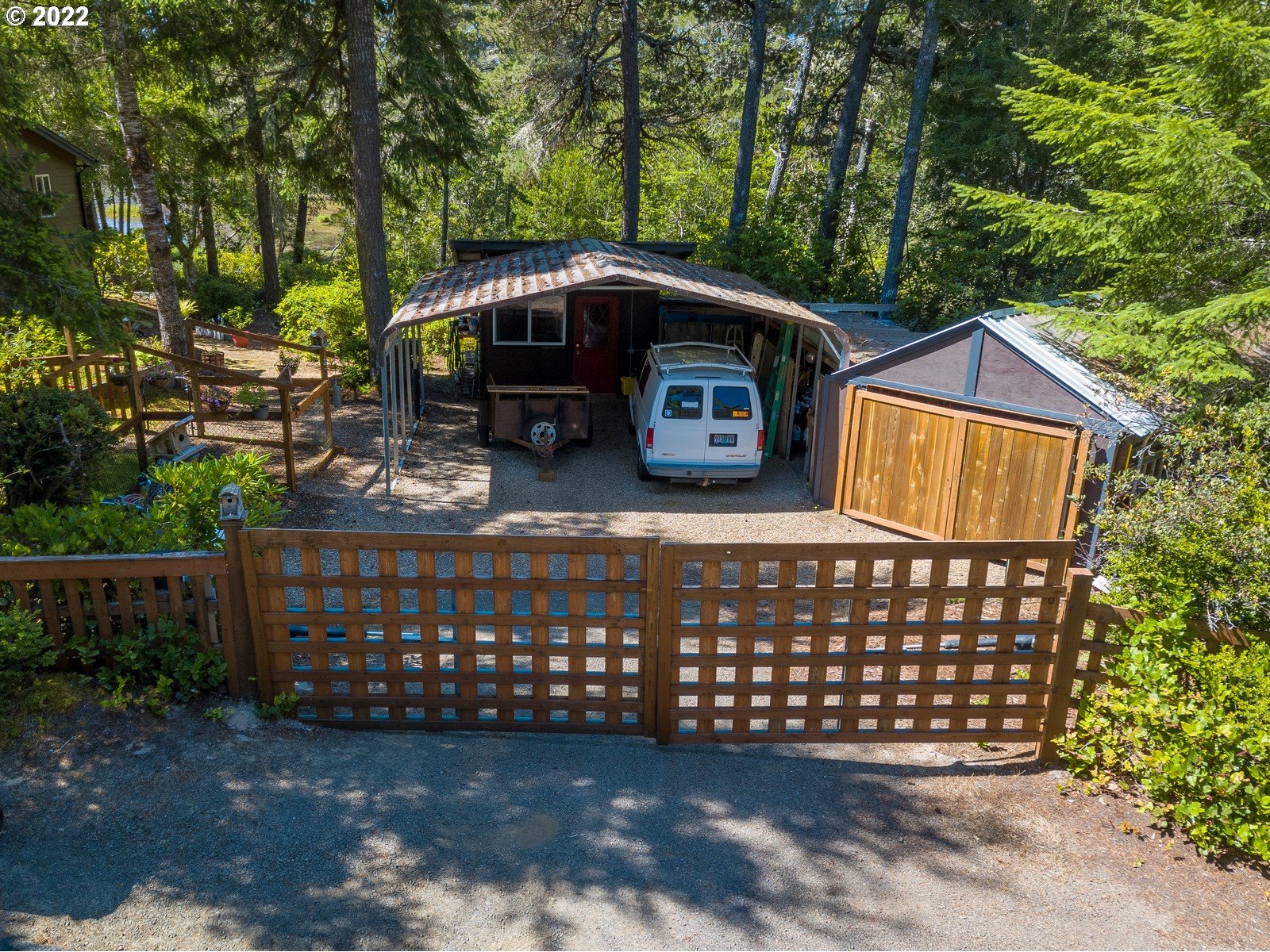 5732 Nicholson Road Florence, OR 97439 - Photo 6 of 31 a view of a wooden house with large trees