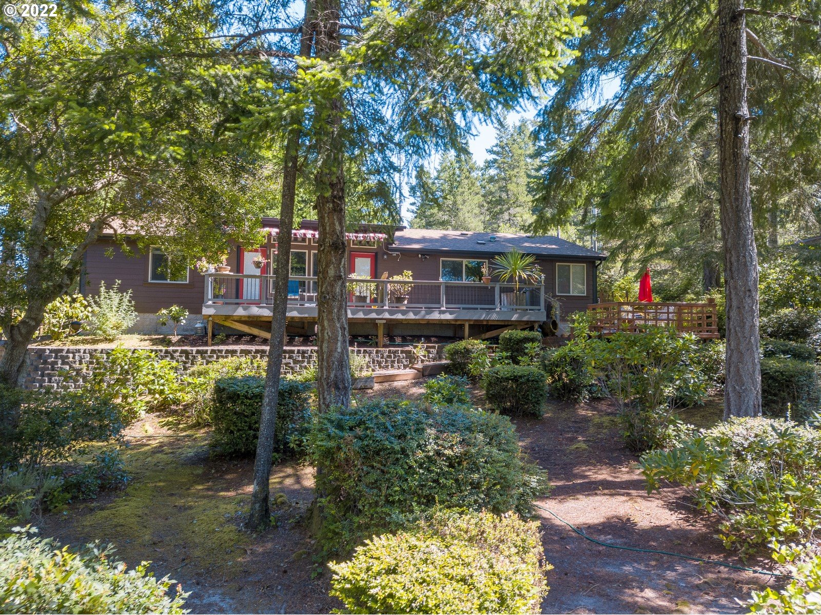 5732 Nicholson Road Florence, OR 97439 - Photo 7 of 31 a view of a house with a yard and a floor to ceiling window