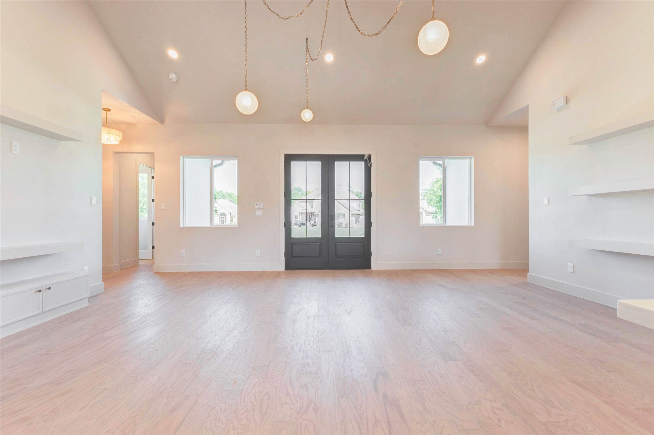 4426 Warington Fulshear, TX 77441 - Photo 3 of 42 an empty room with wooden floor and windows