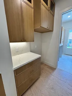 a utility room with wooden floor washer and dryer