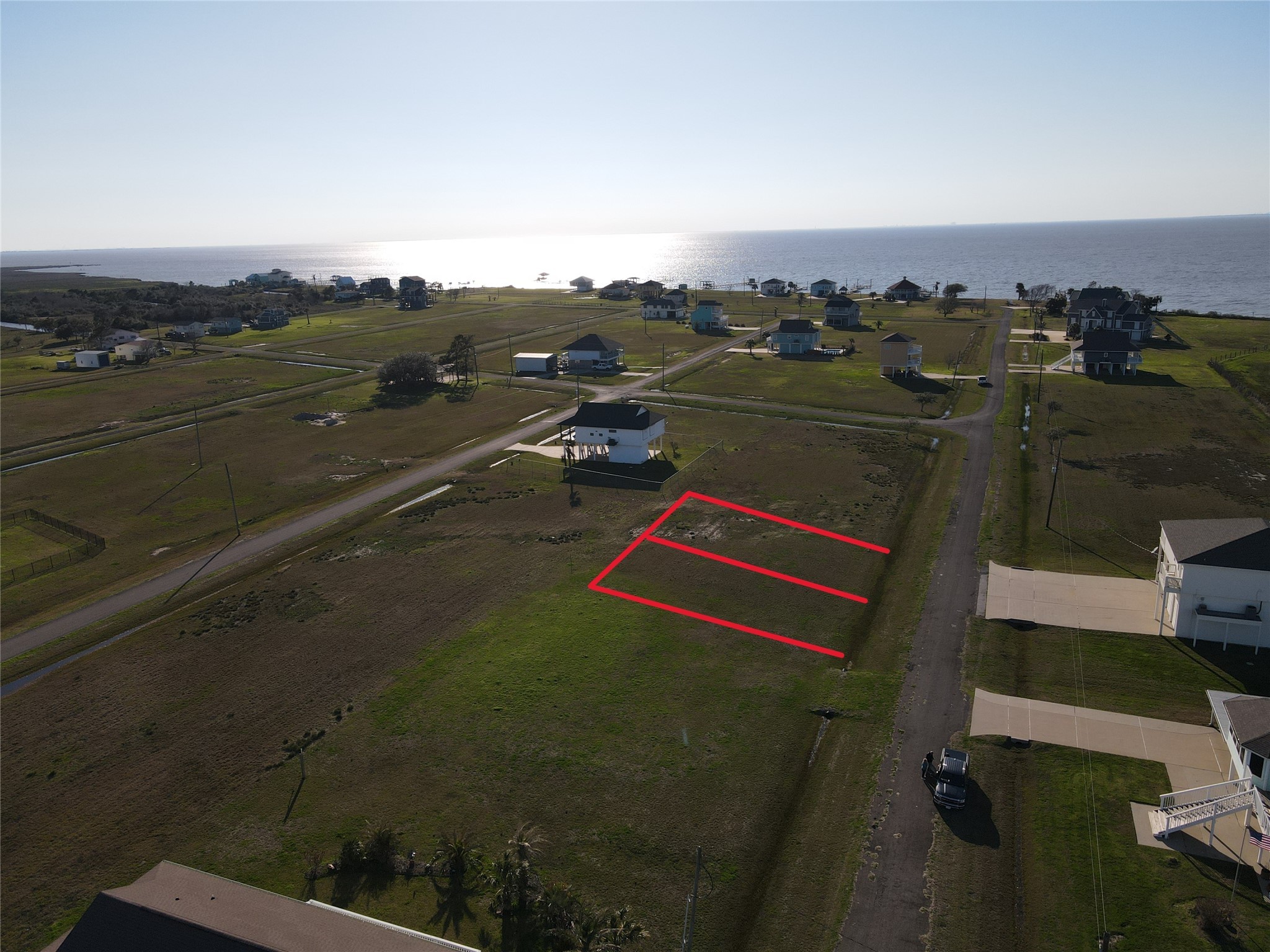 7-8 Cardinal Lane Anahuac, TX 77514 - Photo 4 of 9 an aerial view of a houses with a lake