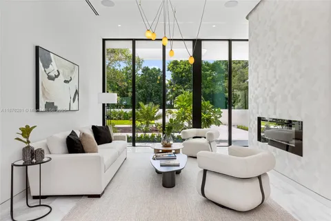 a living room with furniture and a floor to ceiling window