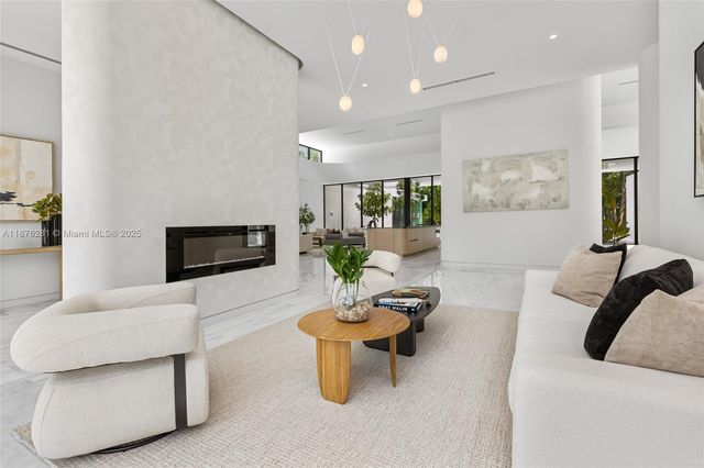 a living room with fireplace furniture and a flat screen tv