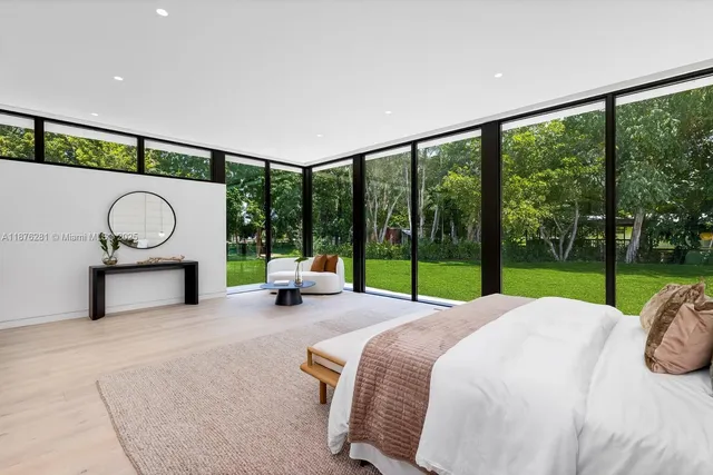 a bed room with a bed and a view of balcony