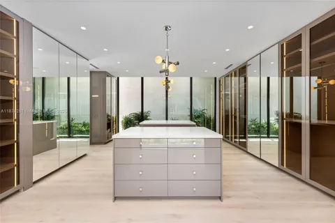 a large kitchen with kitchen island a counter space a sink appliances and cabinets