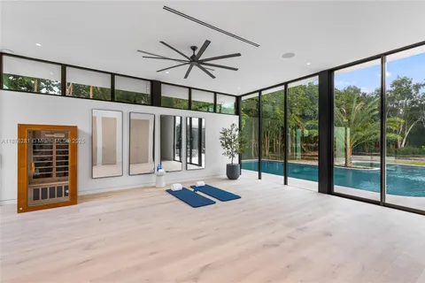 a view of a room with gym equipment and windows