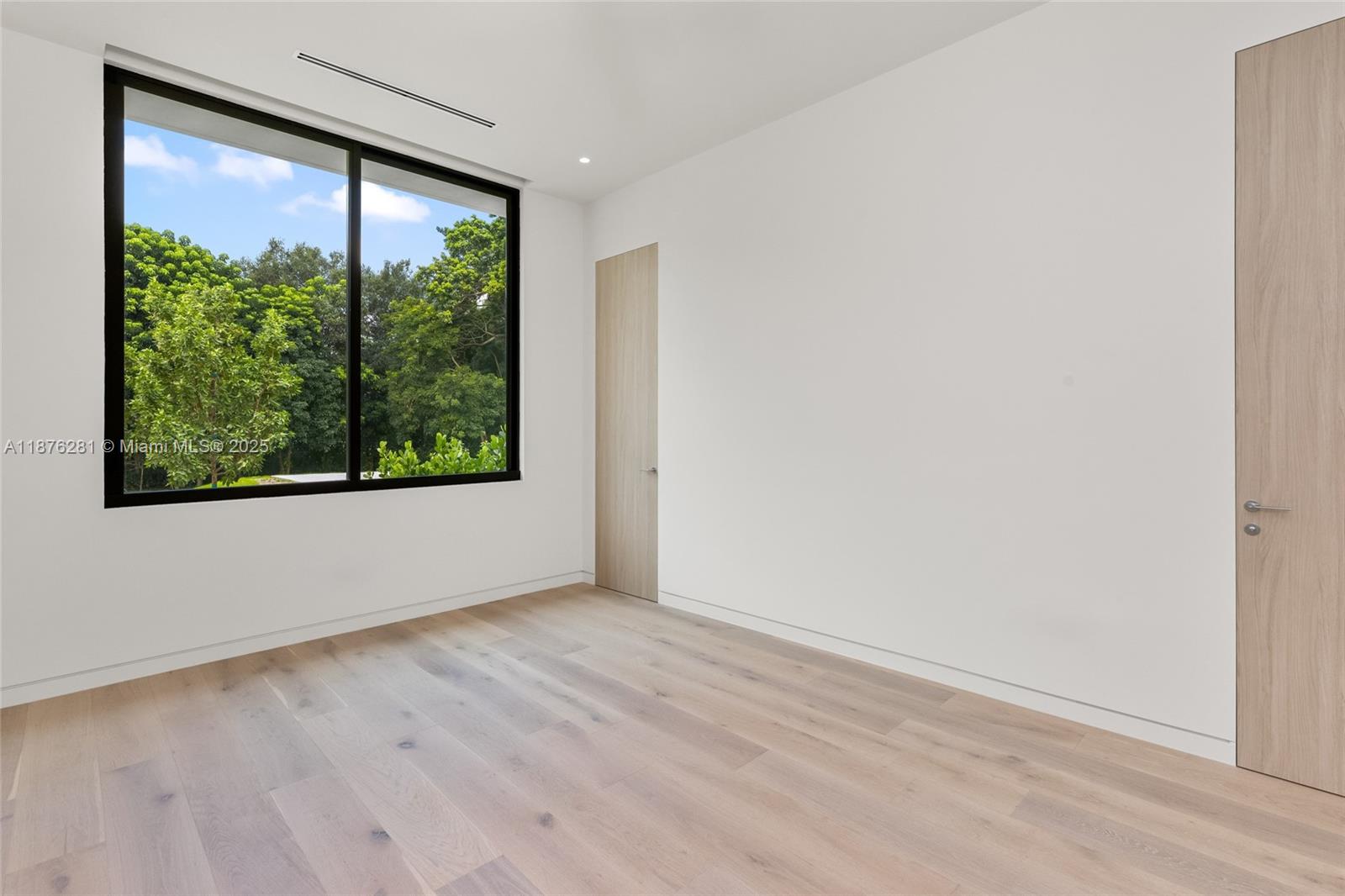 5671 Southwest 130th Avenue Southwest Ranches, FL 33330 - Photo 28 of 47 an empty room with wooden floor and a window
