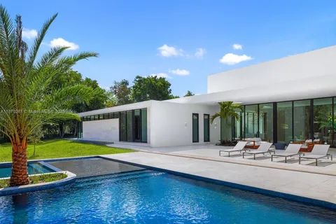 a swimming pool with outdoor seating and yard