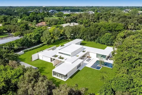 an aerial view of a house with pool yard and outdoor seating