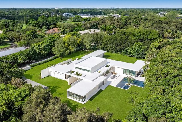 an aerial view of a house with pool yard and outdoor seating